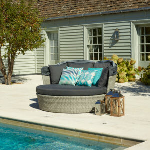 Circular_Garden_Daybed_By_Swimming_Pool_On_Sunny_day
