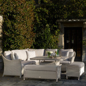 Light_grey_garden_sofa_with_benches_in_courtyard_with_ivy_wall_behind