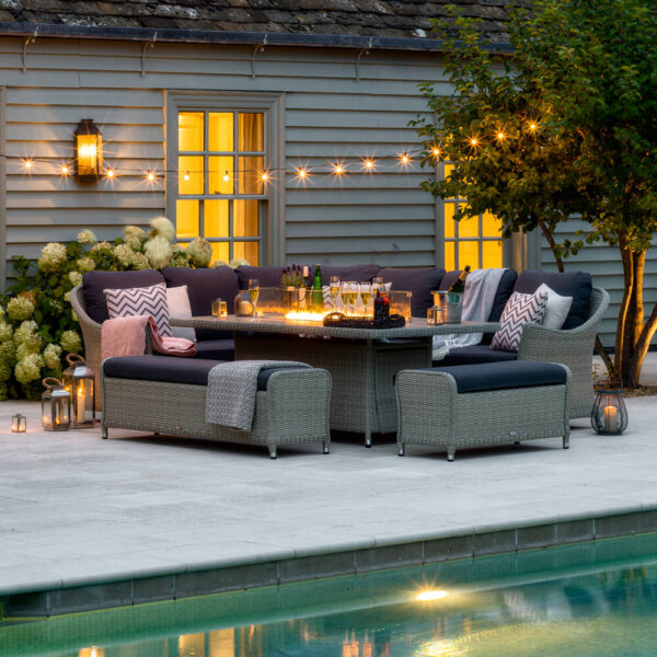 2021 Bramblecrest Monterey 8 Seater Dining Set with a Fire Pit table Next to a Swimming Pool