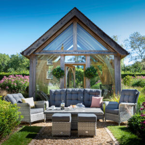 sun_drenched_garden_furniture_in_amongst_garden_flower_bushes