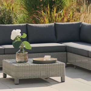 2021 Kettler Palma Low Lounge Corner Sofa Set on a patio with flowers in a jug on the table