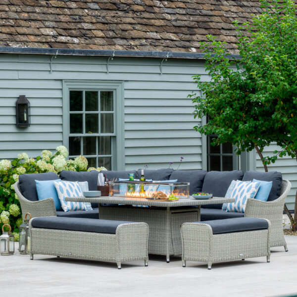Bramblecrest Monterey Large Rectangle Firepit Dining Table Set in dove grey with fire lit and table set