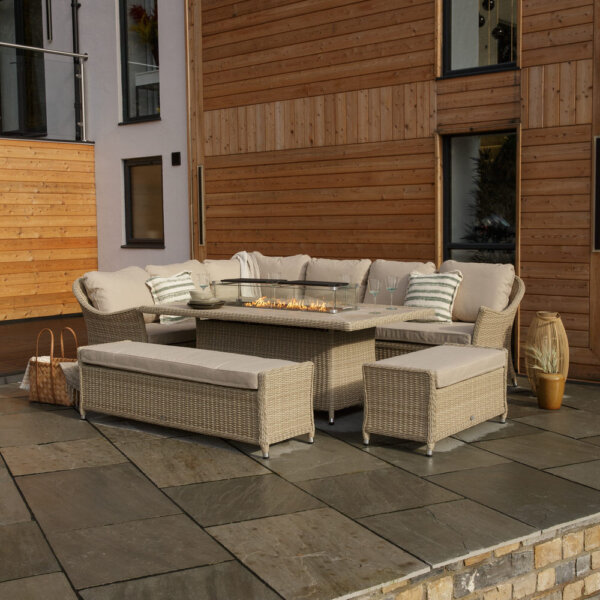 Bramblecrest Monterey Garden Sofa Set With Rectangle Fire Pit Dining Table & 2 Benches – Sandstone 3/4 angle with fire pit on from further back