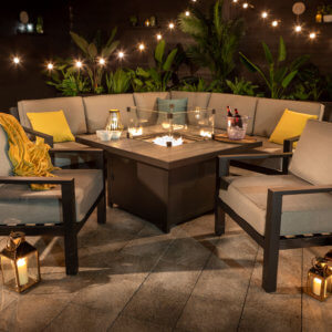 night time shot of garden fire pit table with drinks and lighting and candles