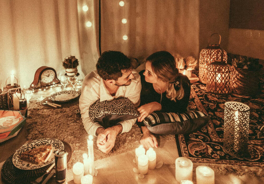 Woman and Man on their lounge floor enjoying some Romantic at-home Valentine's day ideas