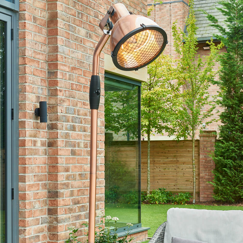 Kettler Copper Standing Floor Heater in garden space next to house