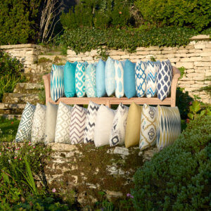 assortment of outdoor cushions arranged on outdoor storage shelves in a garden