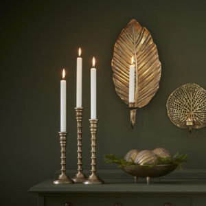 three candle and a wall-mounted candle holder with lit candles