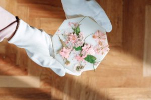 person-in-gloves-holding-dried-flower-clippings