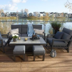 Bramblecrest La Rochelle Reclining 3 Seat Sofa 2 Armchair Set with Adjustable Dining Table with 2 x stools- Anthracite/Dark Grey- on wooden patio in front of lake