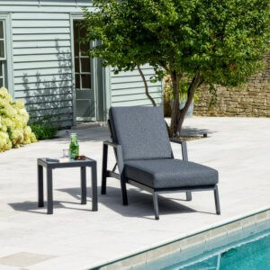 Bramblecrest La Rochelle reclining lounger on a patio next to a swimming pool