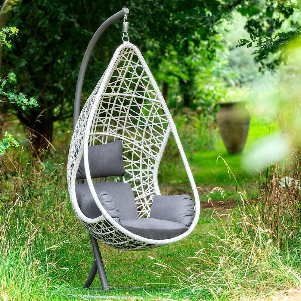 Bramblecrest Tetbury Teardrop Single Cocoon Chair in cloud in garden setting