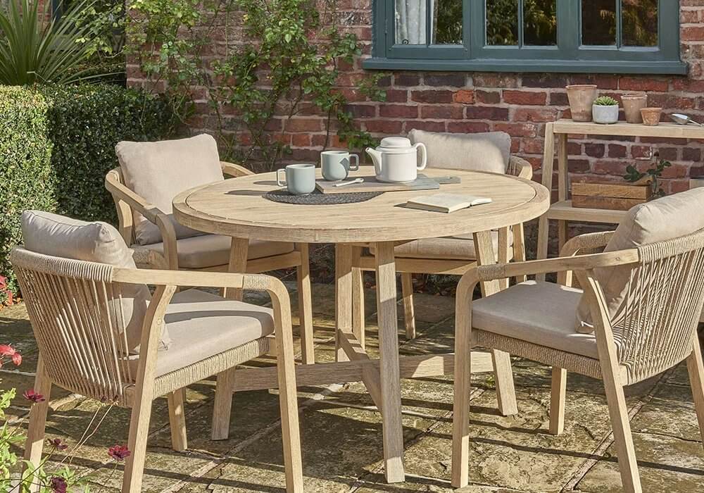 Kettler Cora Round Dining Table Set placed in a courtyard with tea laid on the table