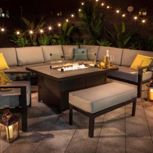 Hartman Apollo fire pit dining set at night with fairy lights hung in surrounding patio area