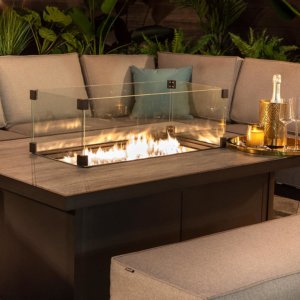 Hartman Apollo fire pit dining set with a tray of glasses and a bottle placed on the table