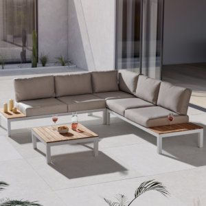 Kettler Elba Low Lounge Corner Sofa Set - White/Teak on white paved patio next to open lounge doors. glass and bowl on table