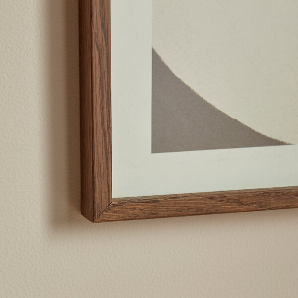 Slim grained wood corner segment showing an art picture frame