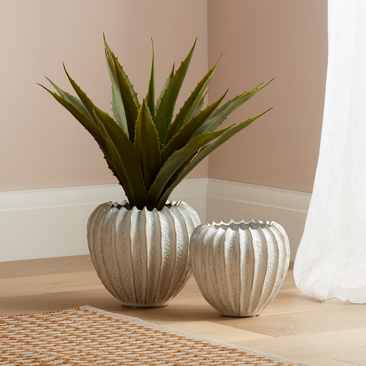 small chelburn plant pot and large chelburn plant pot on a wooden floor