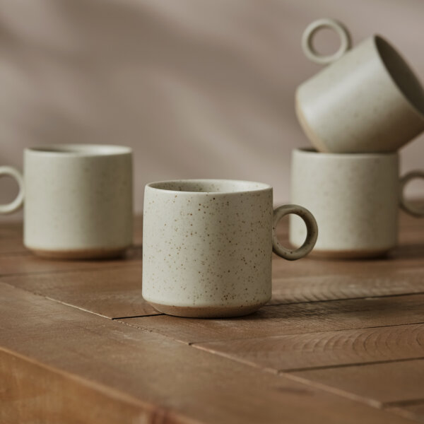 four beige ceramic mugs with ring handles