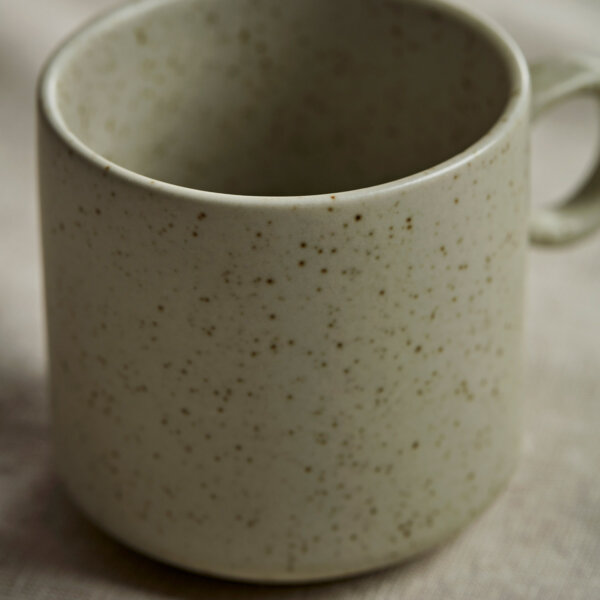 four beige ceramic mugs with ring handles