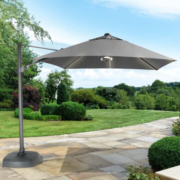 Kettler 3m Free Arm Square Parasol With LED Lighting and Wireless Speaker - Grey / Slate on a sandstone patio