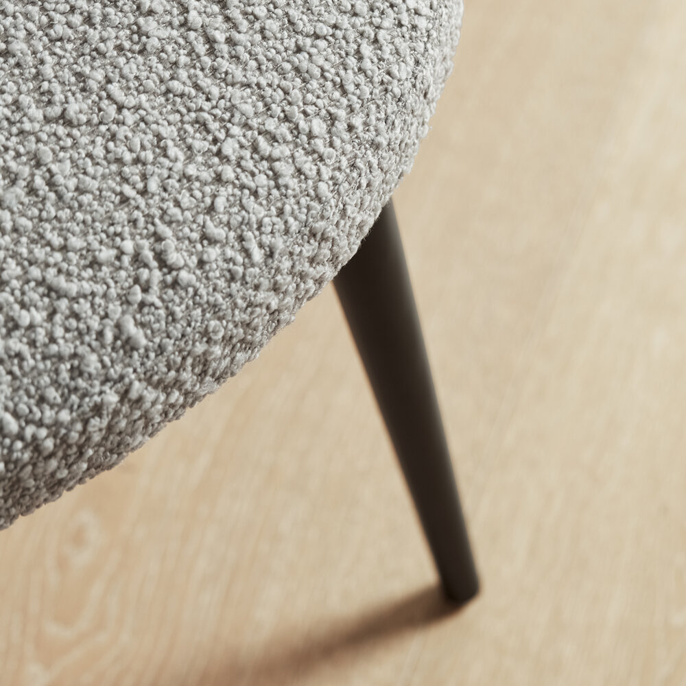 Grey tone teddy fabric cupped Burnham chair corner with black wood legs
