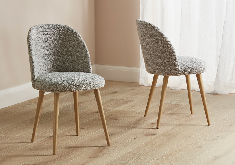 Burnham dining chairs in mink with natural wood legs placed on a wooden floor