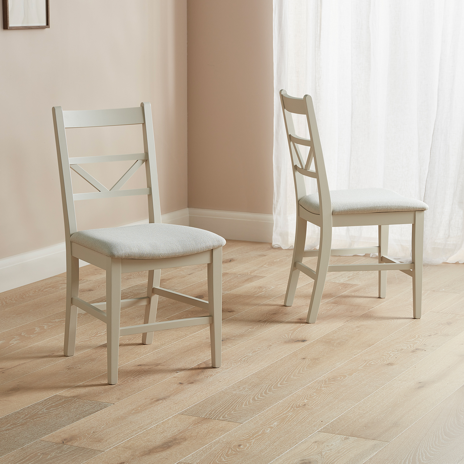 Modern Farmhouse dining chairs with chevron backs on a wooden floor