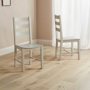 Modern Farmhouse Ladder Back dining chairs placed on a wooden floor