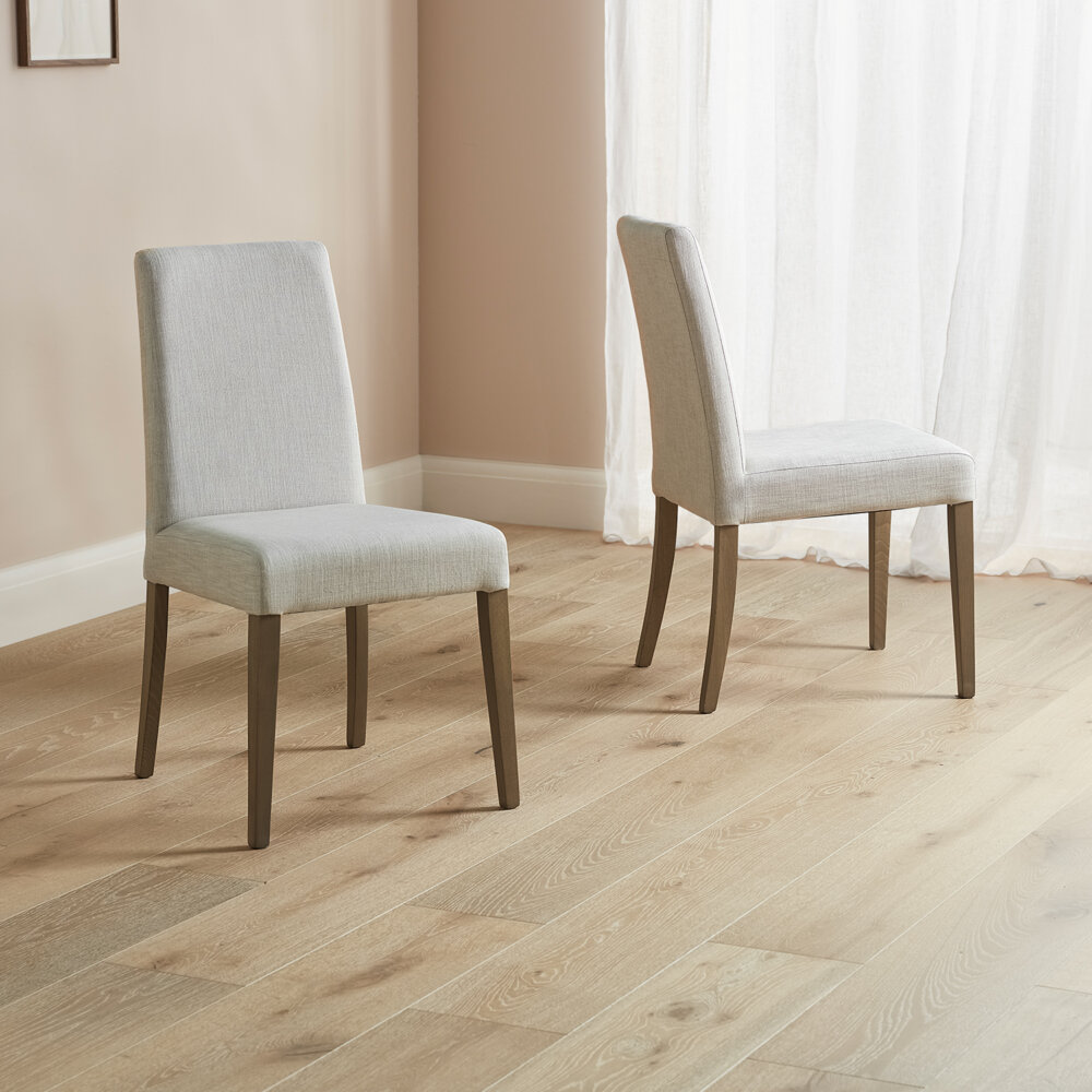 Light grey dining chairs all fabric with dark wood legs