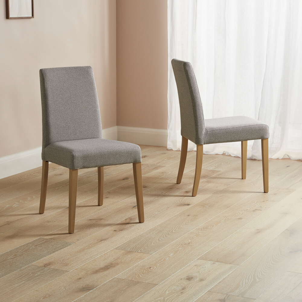 Two grey fabric chairs with wood legs