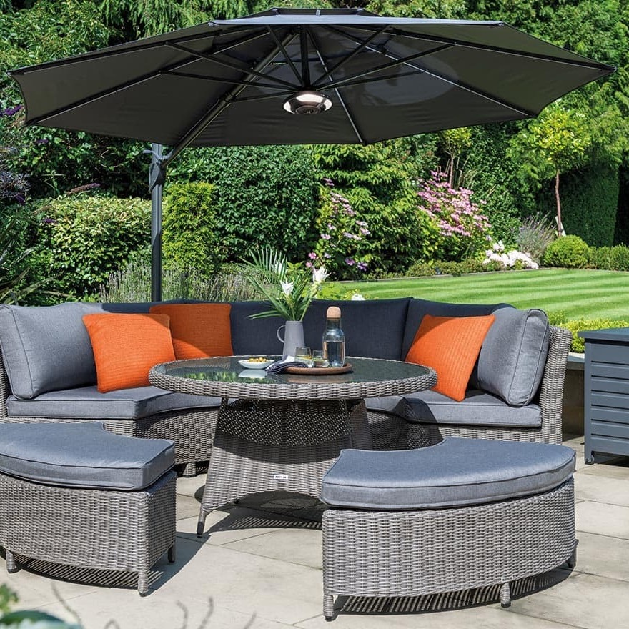 Kettler parasol with LED lighting and bluetooth speaker placed over a garden sofa set